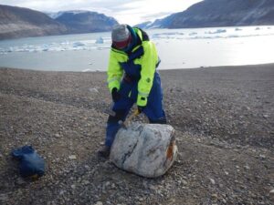 melissa rausche examining a big rock