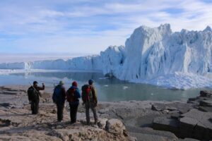 Melissa Reusche and crew at the edge of a glacier